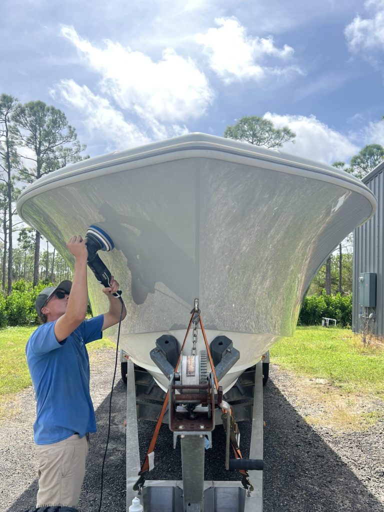 Crew member machine-polishing a bow
