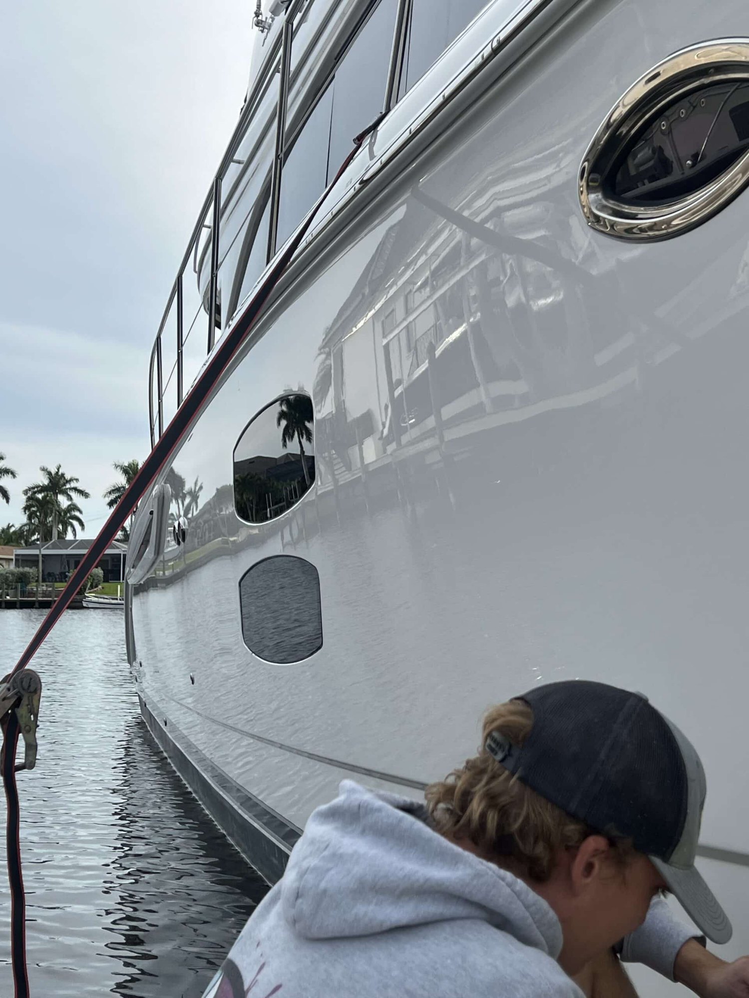 Hands On Deck crew member working along a hull at the waterline