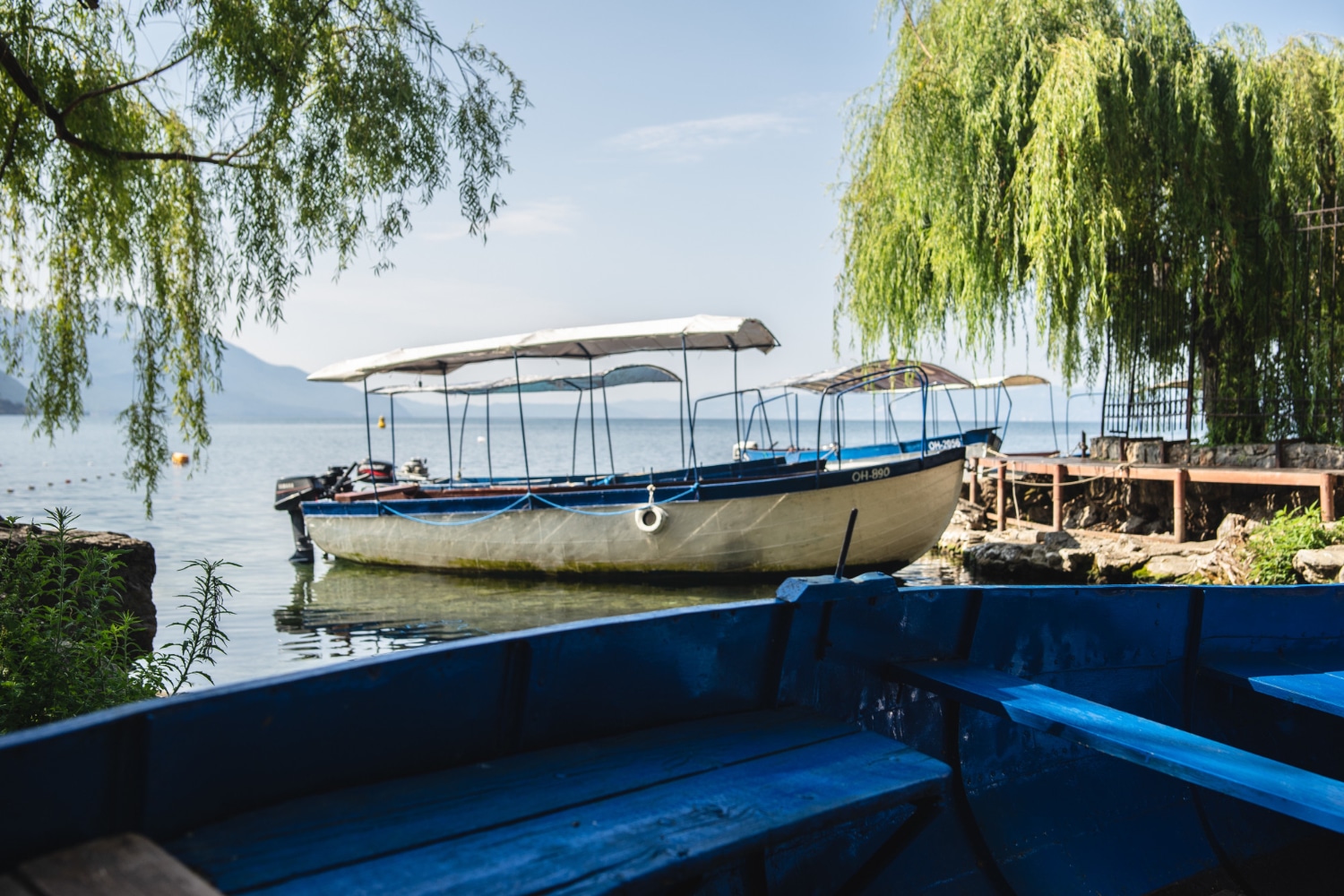 Wooden fishing boats moored on a lakeshore