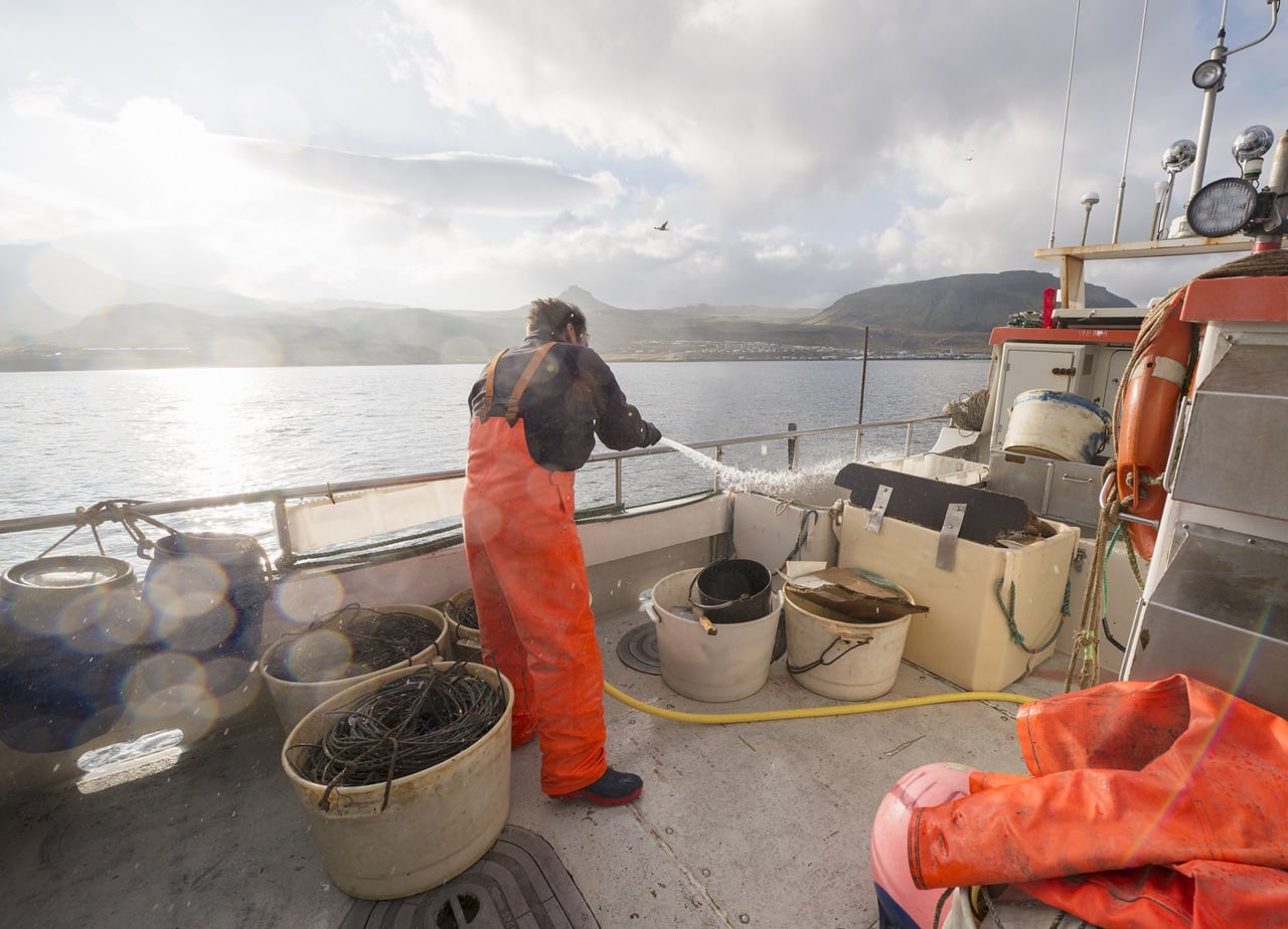 fisherman hosing down fishing boat