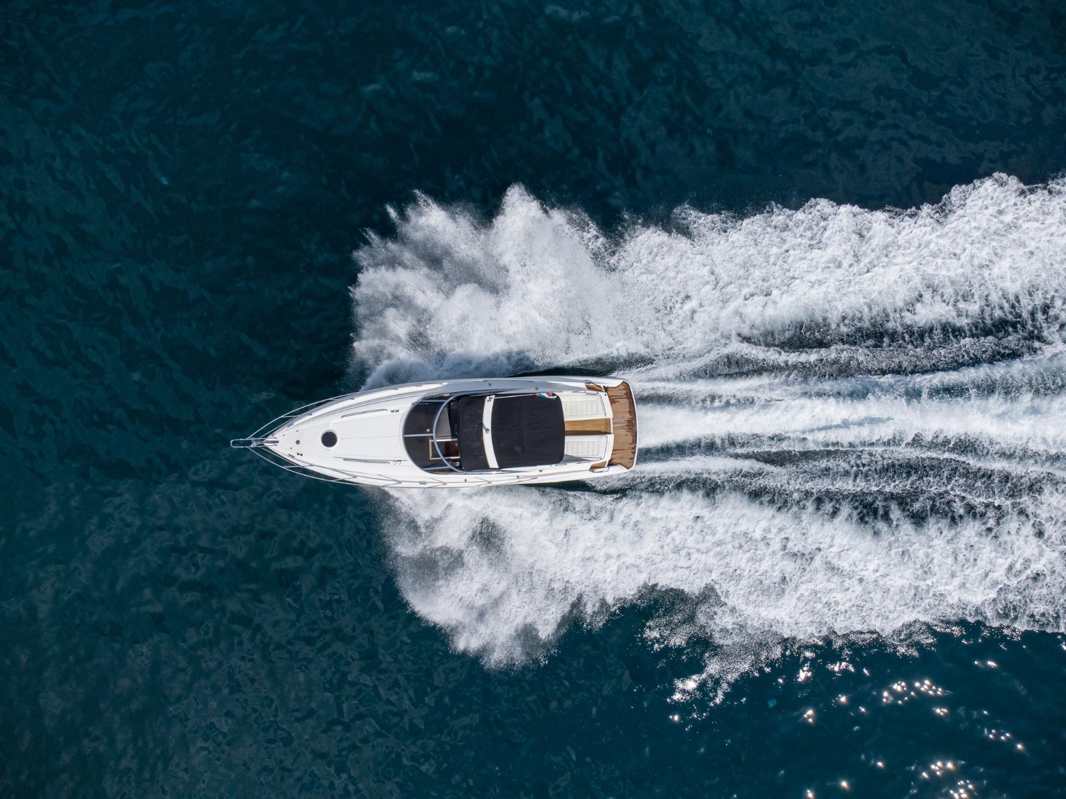 Aerial view of a speedboat leaving a white wake